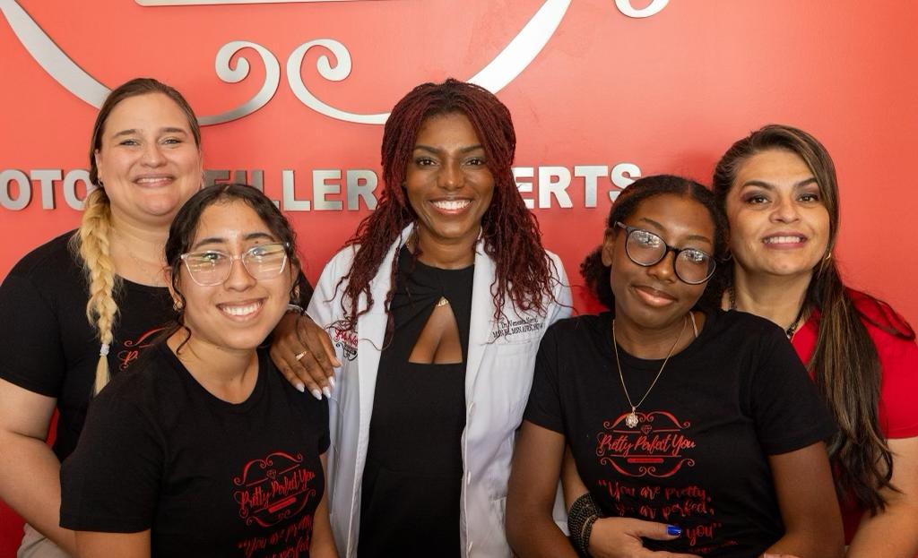 Pretty Perfect You Staff posing alongside Dr. Venessia Norvil