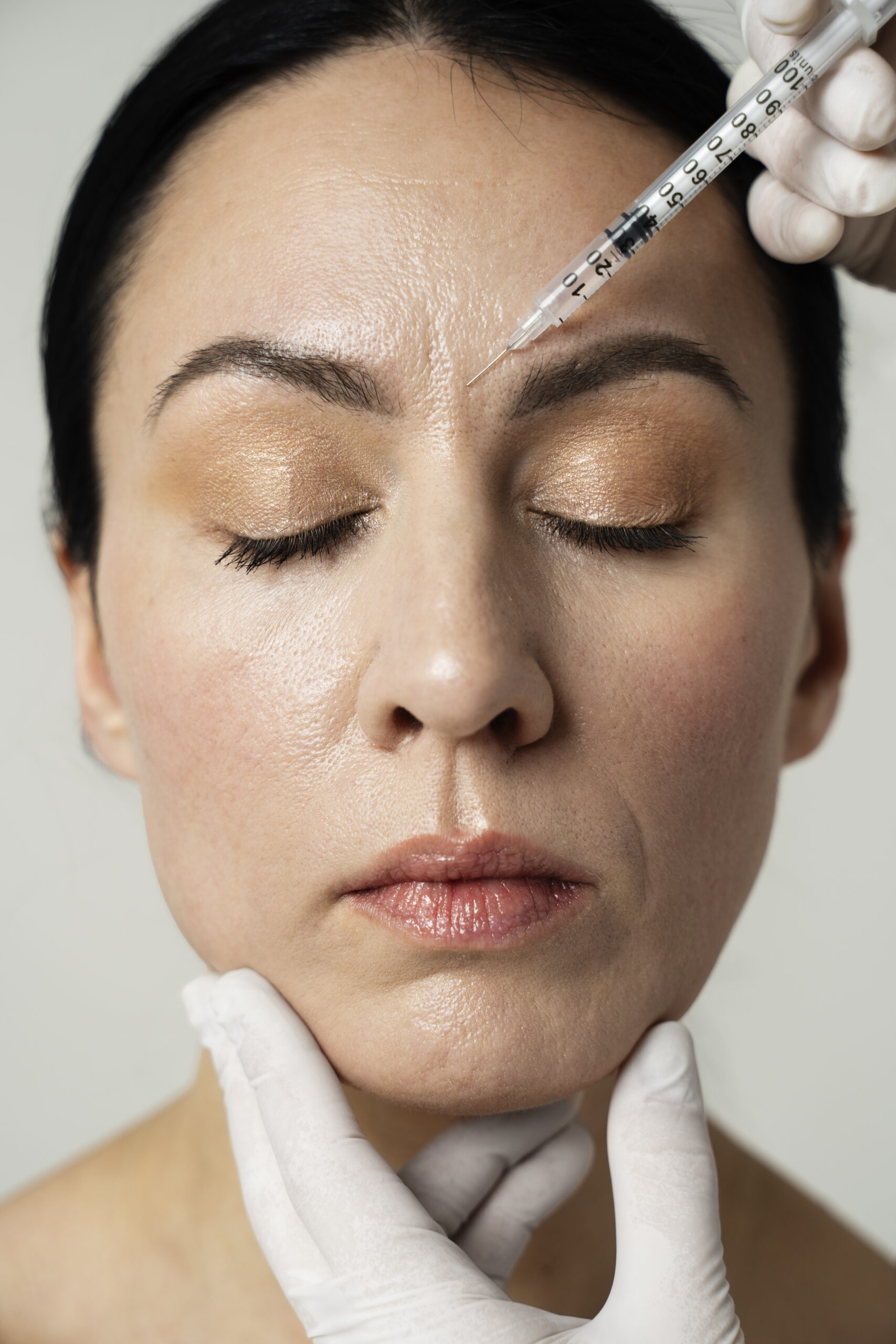 Older woman getting a Dysport unit injected on the forehead