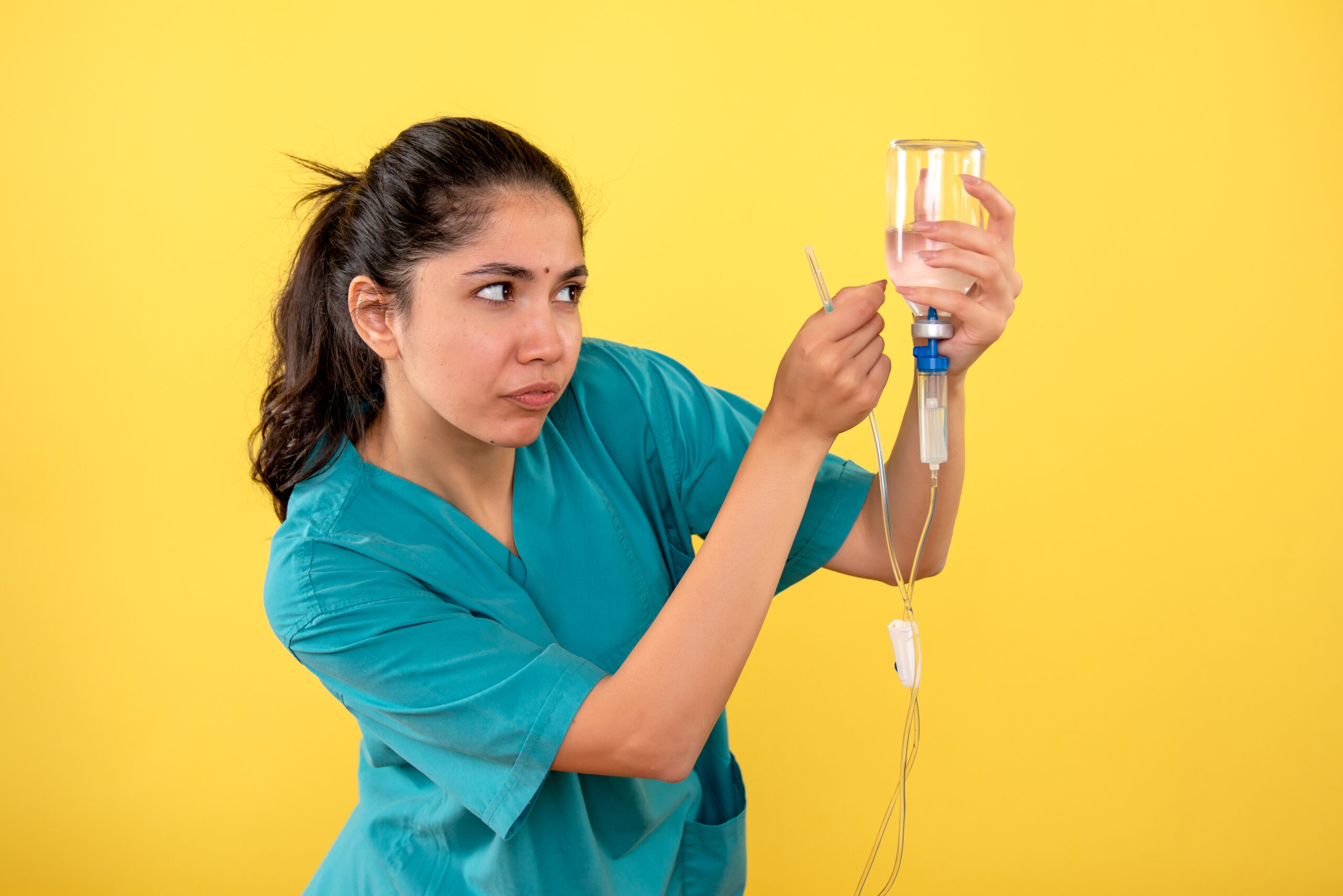 Healthcare professional preparing an IV treatment