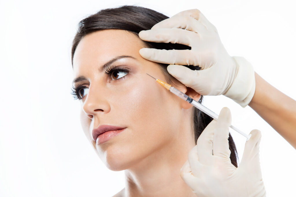 Woman getting a syringe of eye filler